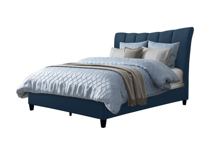 Navy blue channel tufted queen bed with plush velvet upholstery and sleek wooden legs.