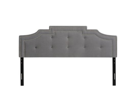 Light grey padded king headboard with tufted design and soft fabric upholstery.