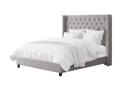 Grey tufted king bed with slats, upholstered fabric, and wooden legs for modern bedroom decor.