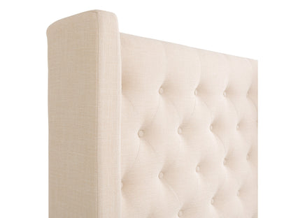 Cream tufted queen bed with slats, upholstered headboard, and wooden legs.