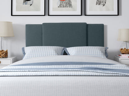 Adjustable blue fabric headboard with tufted design and sleek modern style.