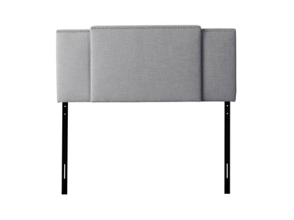 Adjustable grey fabric headboard with tufted design and modern minimalist style.