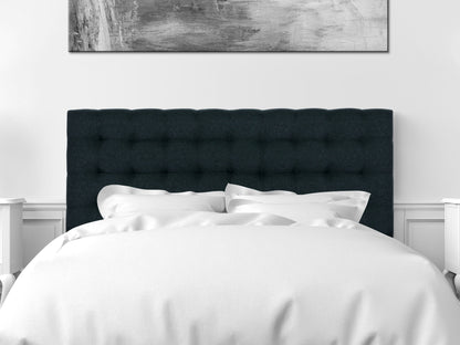 Blue modern queen headboard with tufted fabric, sleek design, and wooden legs in a contemporary bedroom setting.