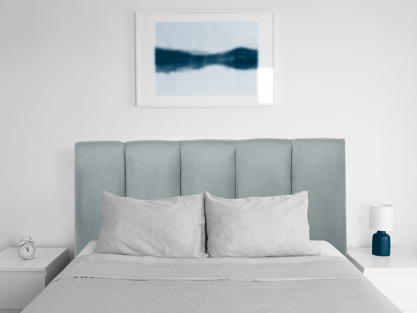 Light blue twin headboard with panel design, upholstered fabric, and sleek minimalist style.