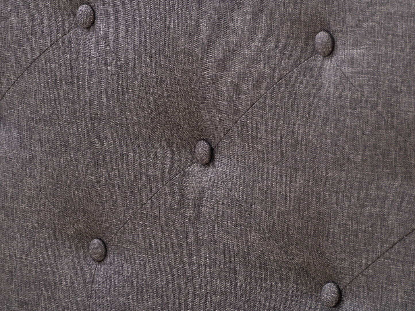 Dark grey button tufted double/full bed with fabric upholstery and wooden legs.