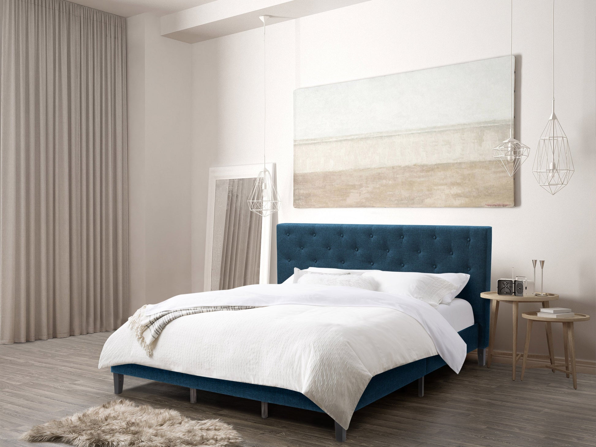 Blue button tufted king bed with upholstered headboard, wooden legs, and luxurious design.