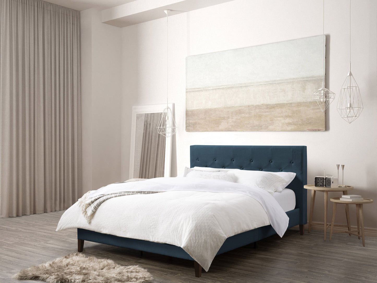 Blue button tufted queen bed with upholstered headboard and wooden legs, elegant and modern bedroom furniture.