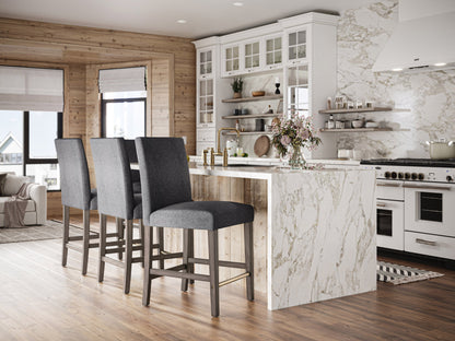 Grey fabric counter height bar stool with tufted cushion, wooden legs, and contemporary design.