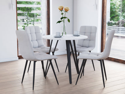 Small round white marble dining table with gold metal base, elegant and modern design.