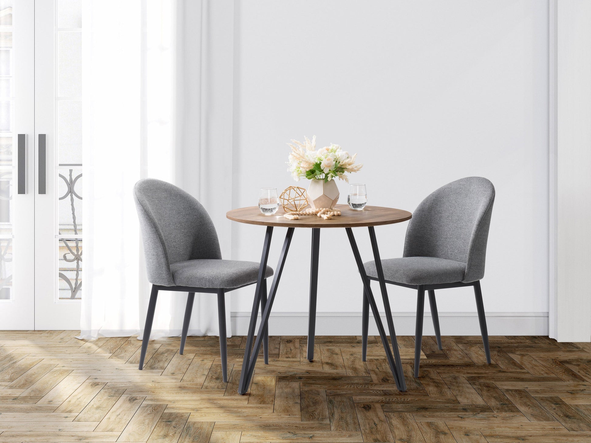 Small round brown dining table with wooden finish and sleek modern design.