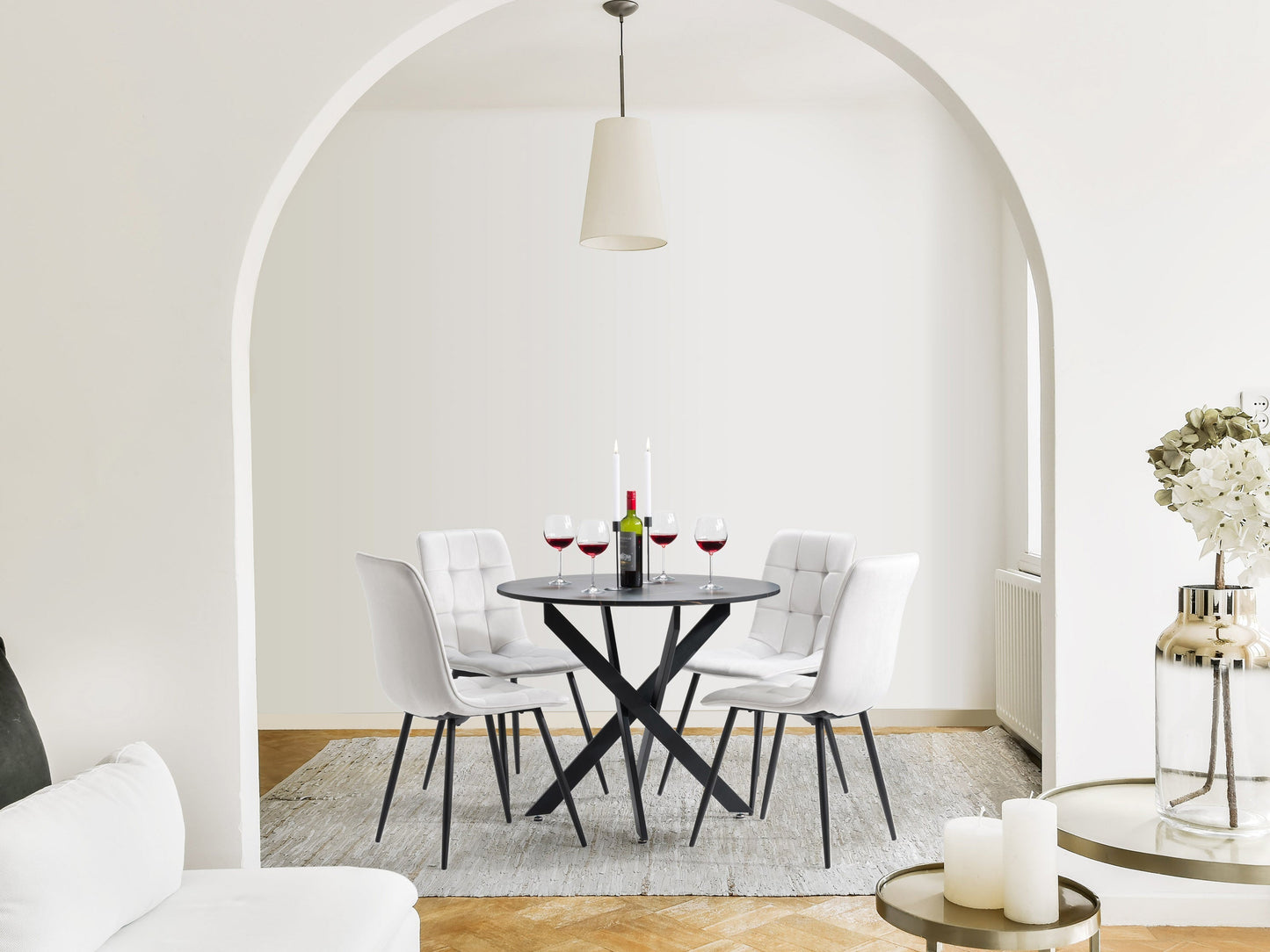 Black dining room set with light grey upholstered chairs, sleek black table, and modern minimalist design.