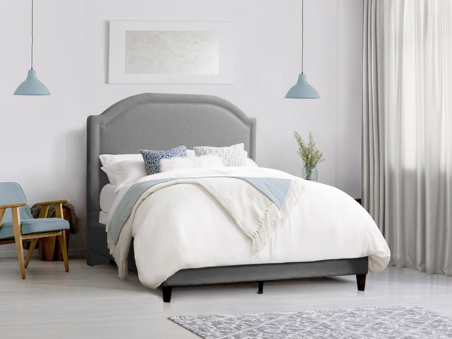 Grey upholstered queen bed with tufted headboard, wooden legs, and modern design.