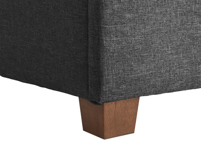 Dark grey large storage ottoman with tufted fabric, wooden legs, and spacious interior compartment.