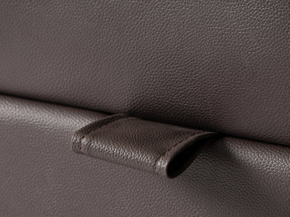 Brown vegan leather storage ottoman with tufted top and hidden compartment.