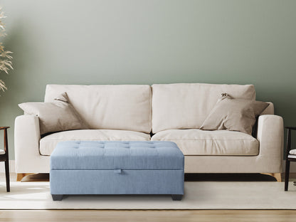 Light blue tufted storage bench ottoman with wooden legs and soft fabric upholstery.