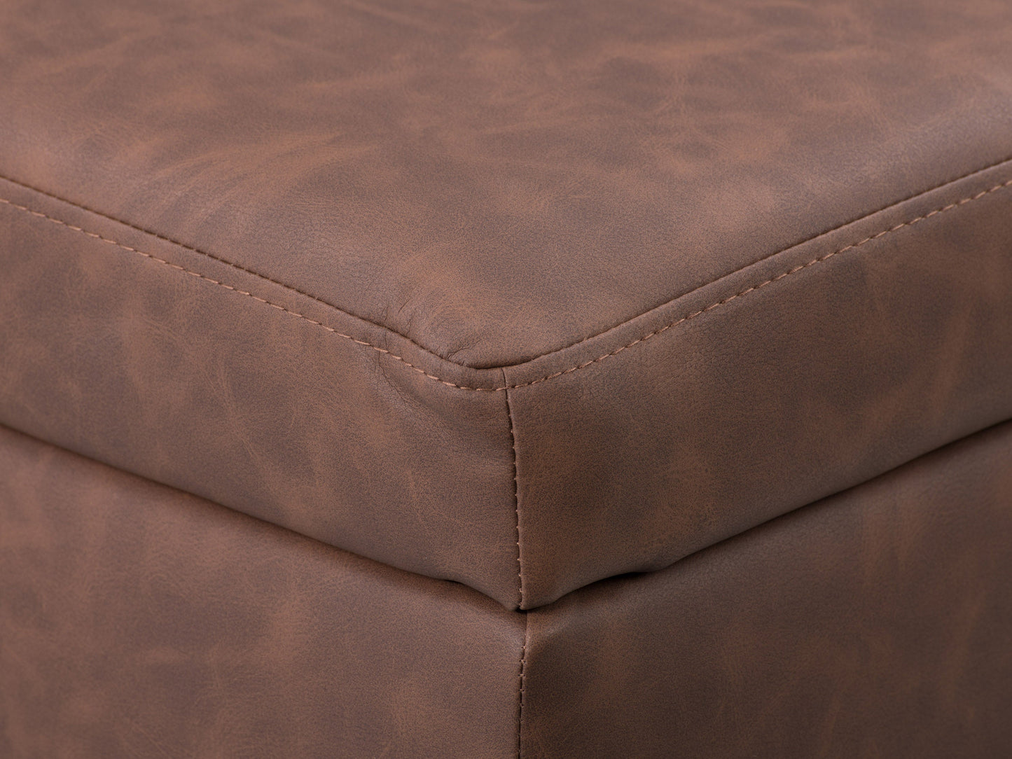 Mid-century modern dark brown ottoman with tufted leather upholstery and wooden legs.