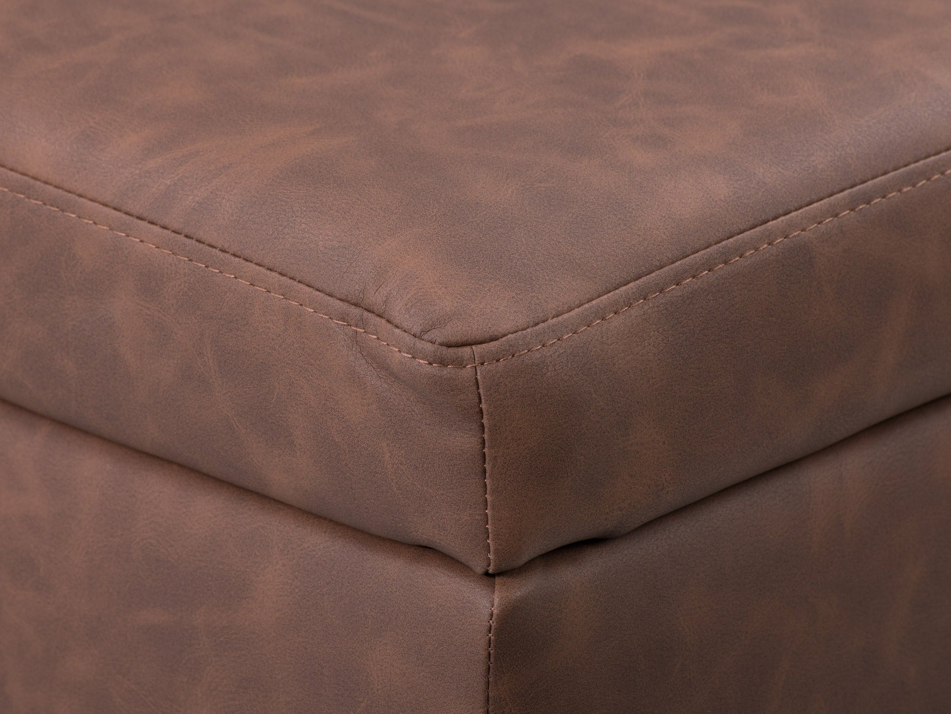 Mid-century modern dark brown ottoman with tufted leather upholstery and wooden legs.