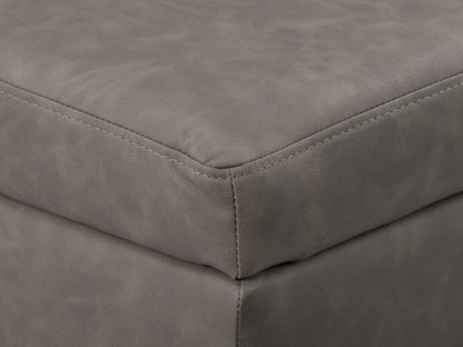 Mid-century modern grey ottoman with tufted fabric, wooden legs, and minimalist design.