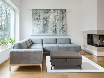 Mid-century modern grey ottoman with tufted fabric, wooden legs, and minimalist design.