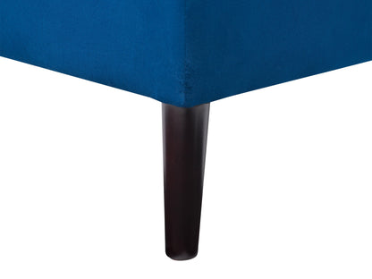 Blue velvet storage ottoman with tufted top and sleek black legs.