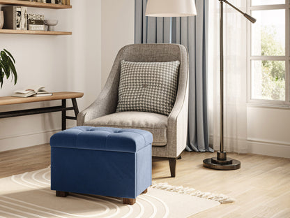 Blue velvet ottoman with storage, tufted top, and wooden legs.