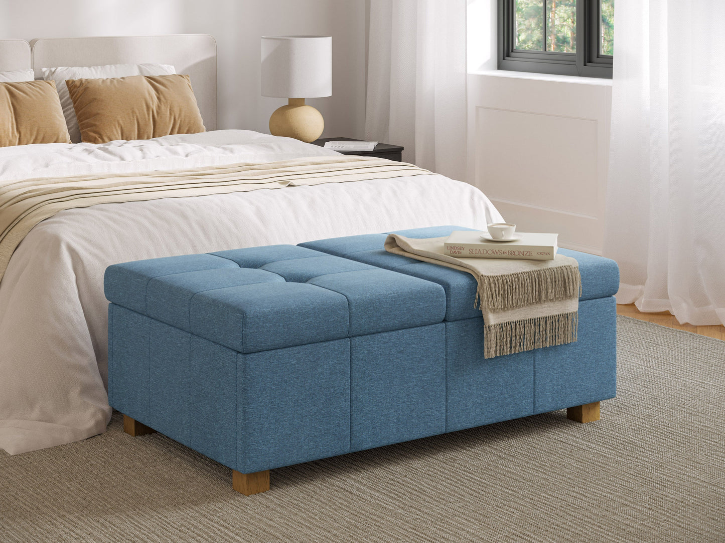 Blue double storage ottoman with tufted top, wooden legs, and spacious interior for living room or bedroom.