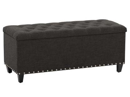 Dark grey tufted storage ottoman with wooden legs and fabric upholstery, perfect for living room or bedroom decor.