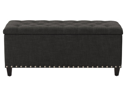 Dark grey tufted storage ottoman with fabric upholstery and wooden legs, perfect for modern living rooms.