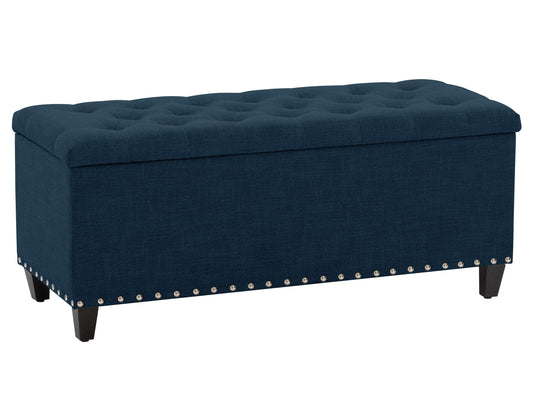 Navy blue tufted storage ottoman with wooden legs and plush fabric upholstery.