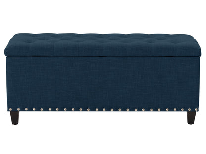 Navy blue tufted storage ottoman with wooden legs and elegant design for modern living rooms.