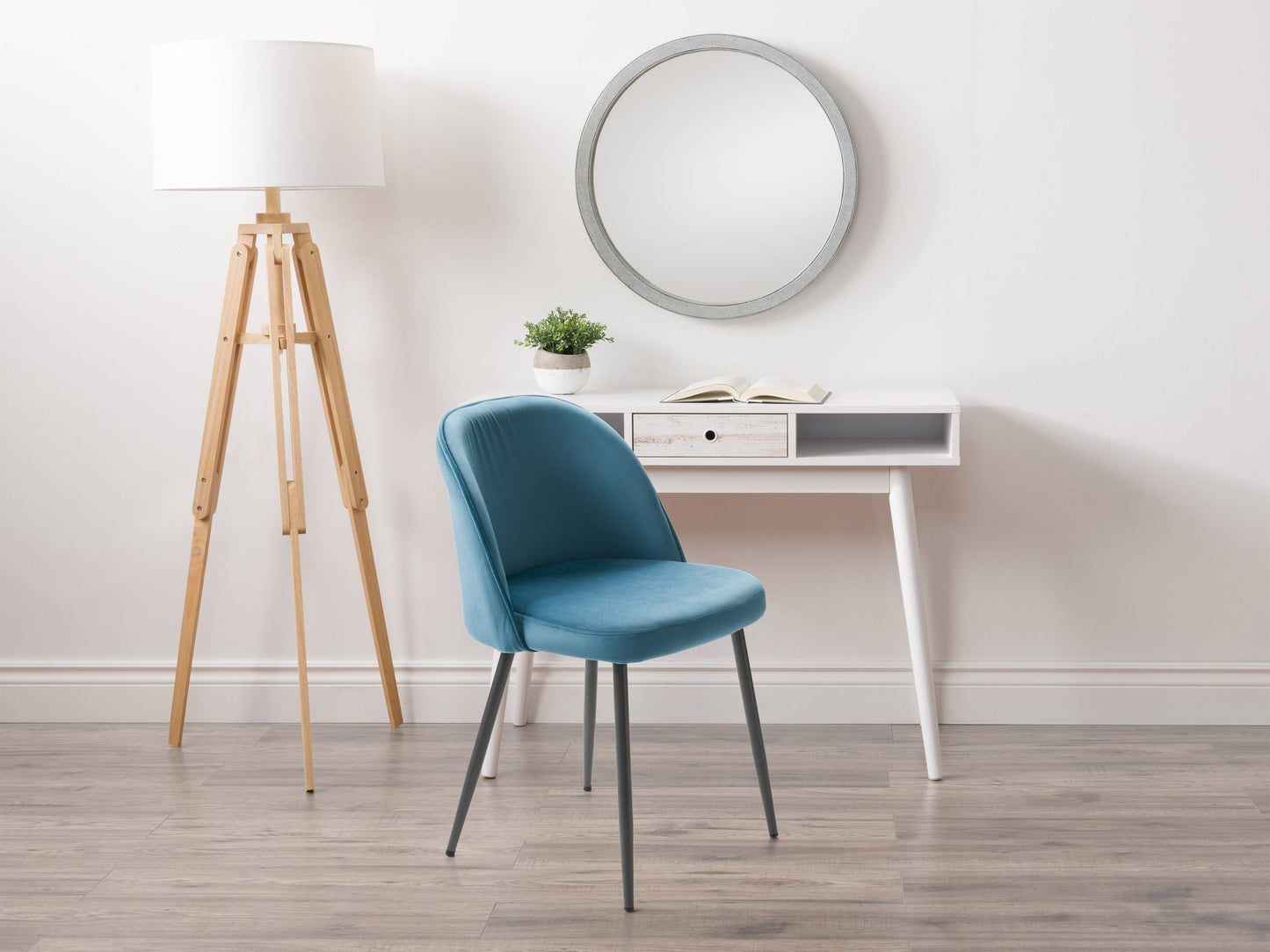 Blue velvet dining chair with gold metal legs, plush upholstery, and contemporary design.