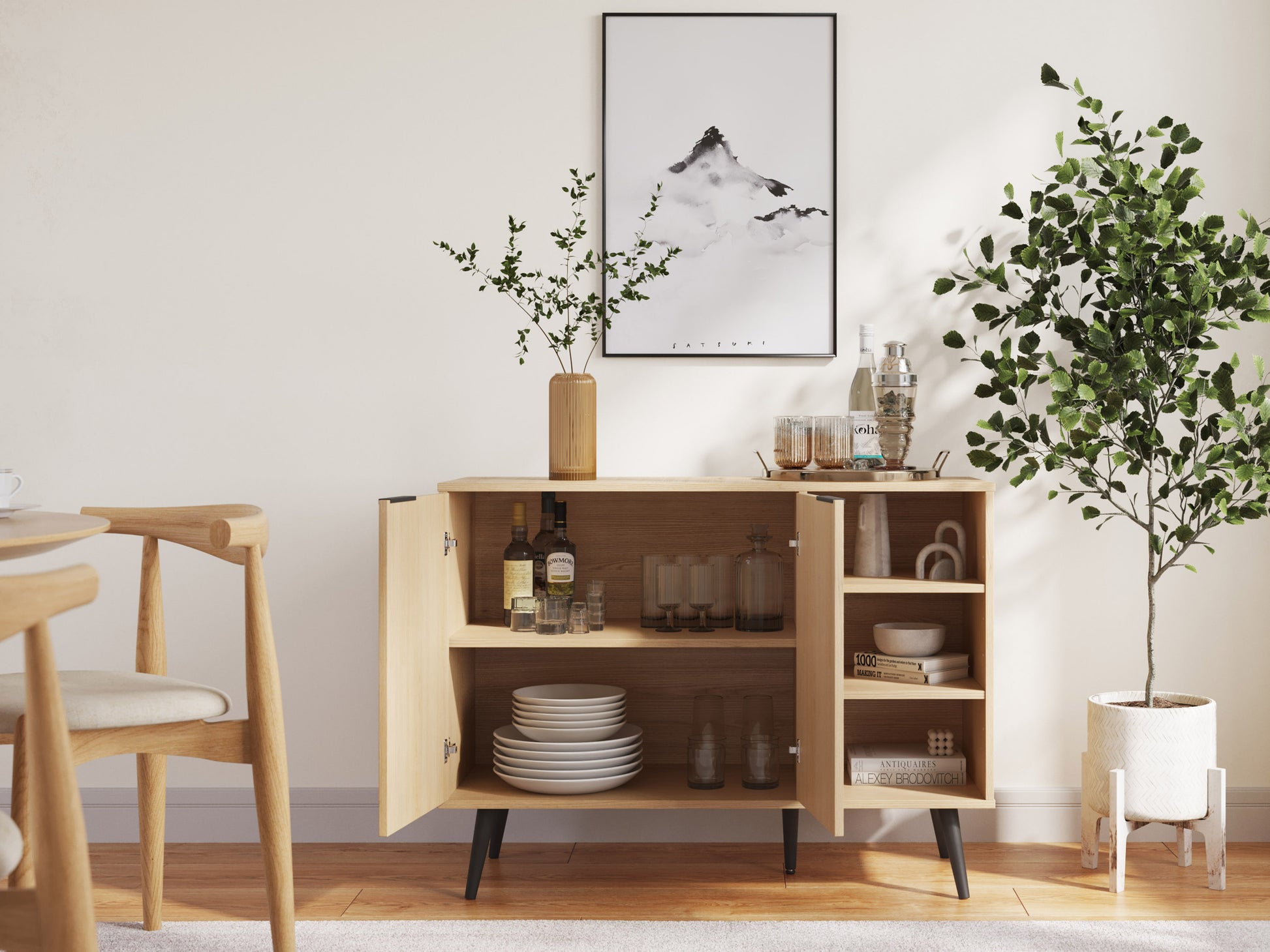 Modern wooden sideboard with a rich walnut finish, featuring three sleek drawers and two cabinets with minimalist black metal handles, set against a white wall and adorned with decorative items on top.