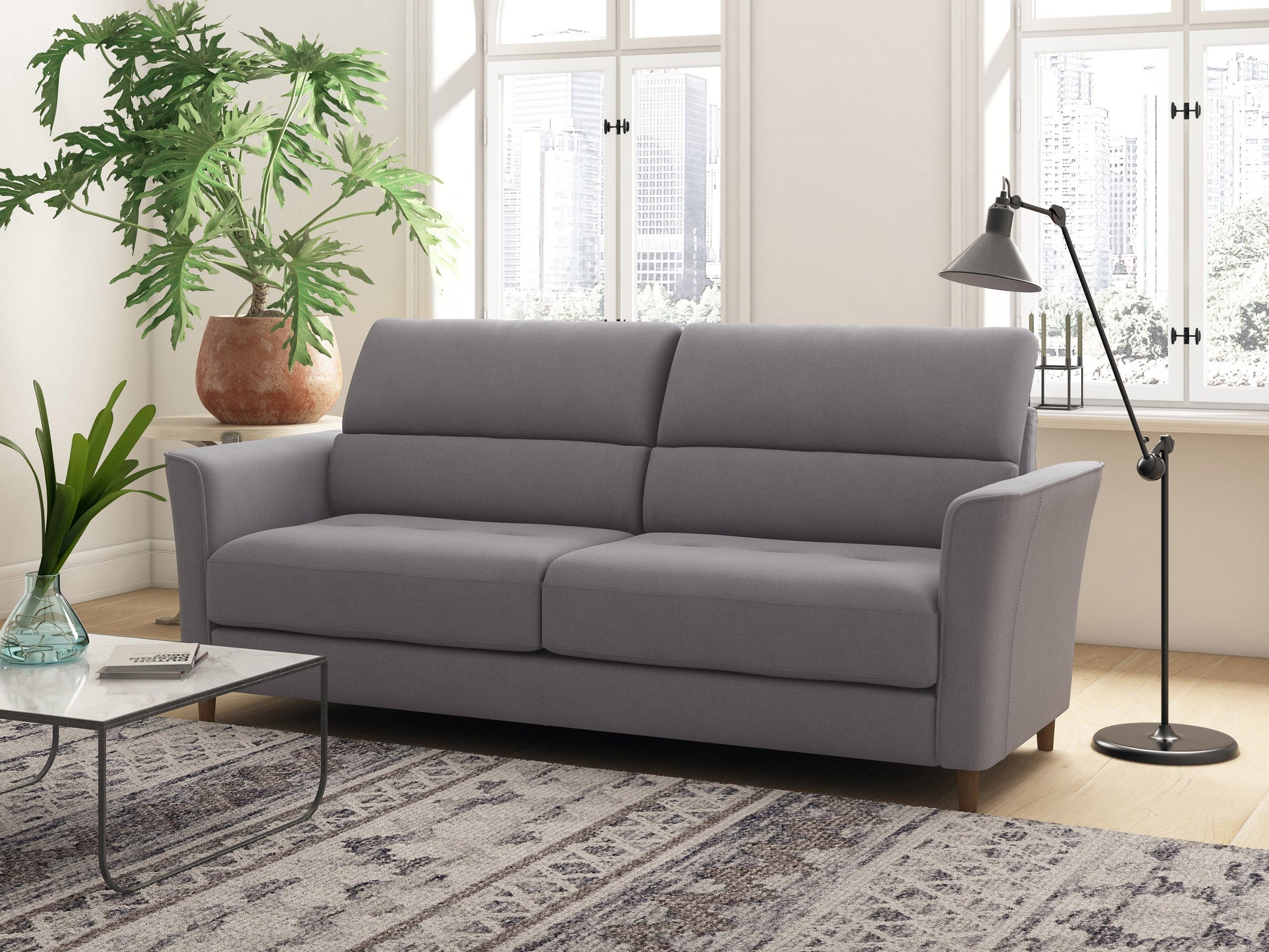 Light grey 3 seater sofa with tufted cushions, wooden legs, and a minimalist design.