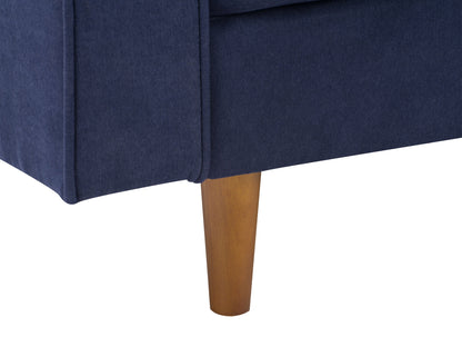 Navy blue mid-century modern arm chair with wooden legs and tufted backrest.