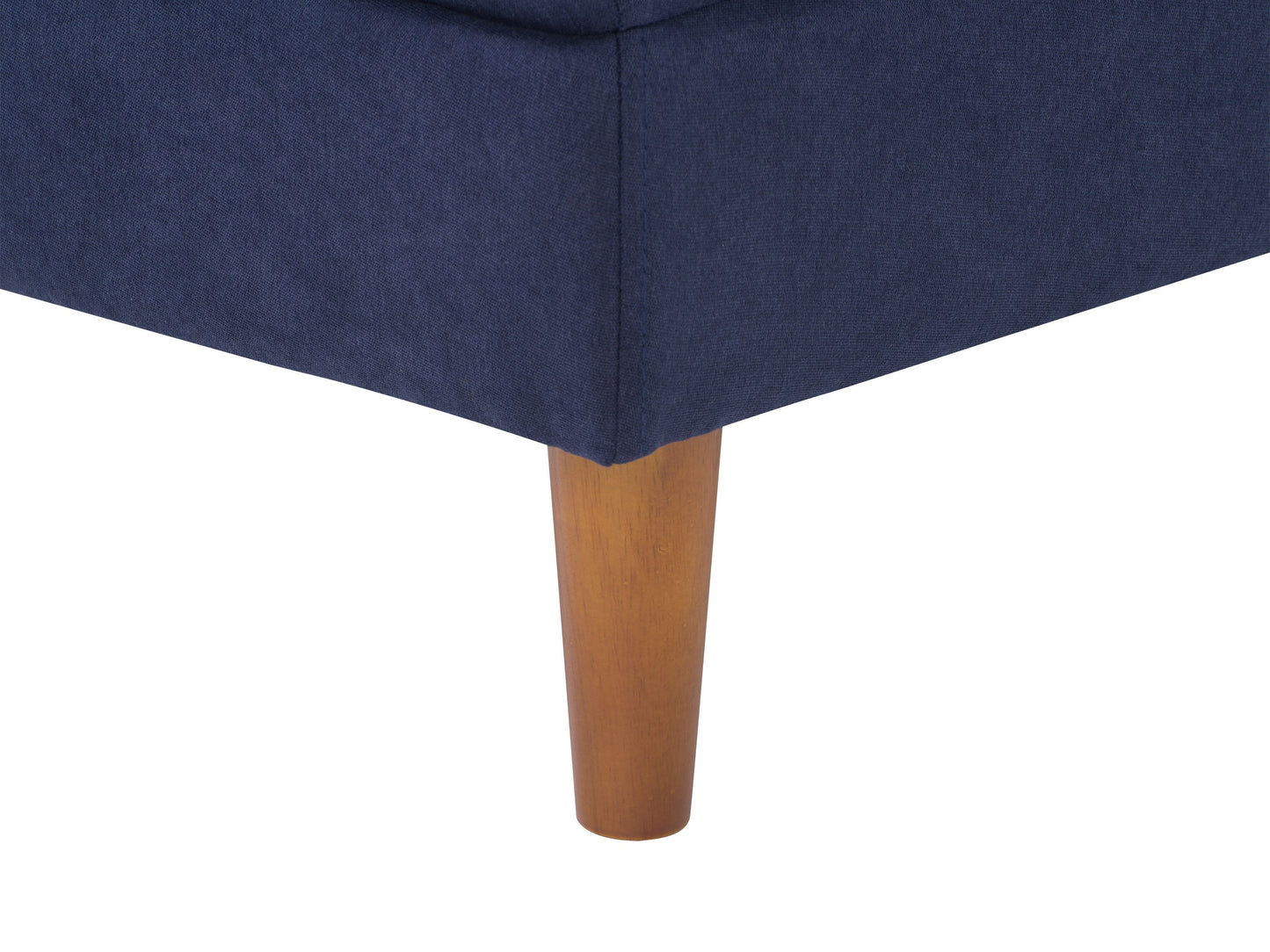 Navy blue mid-century modern ottoman with tufted cushion and wooden legs.