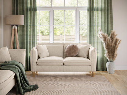 Boucle loveseat with cream fabric, wooden legs, and tufted cushions for modern living room decor.