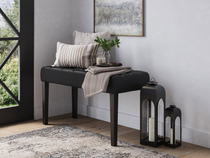 Black leather bench with sleek modern design, tufted seat, and sturdy wooden legs.