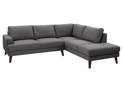 Dark grey sectional sofa, right facing, with tufted cushions, wooden legs, and modern minimalist design.