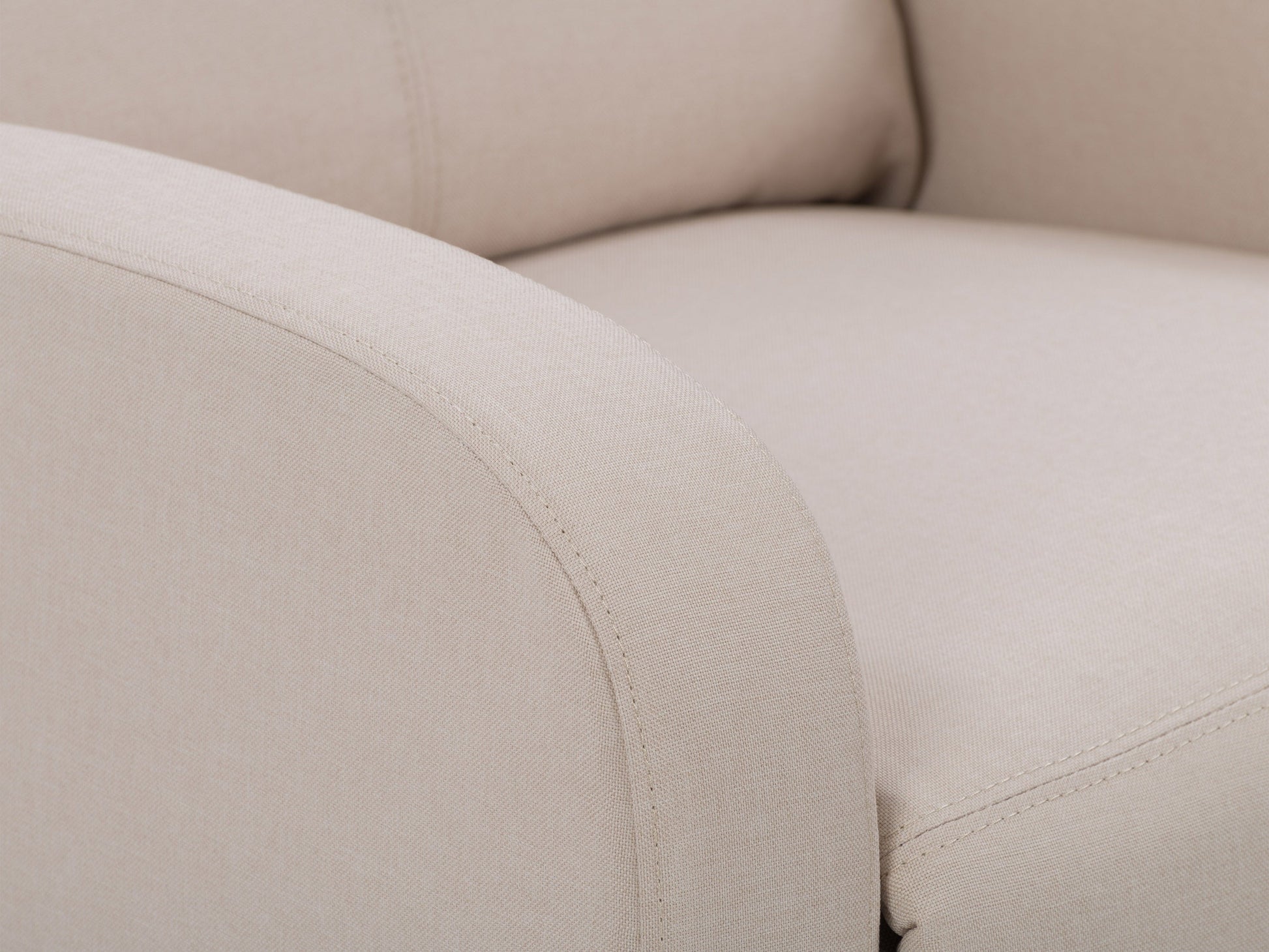 Beige push back recliner with tufted backrest, wooden legs, and soft fabric upholstery.