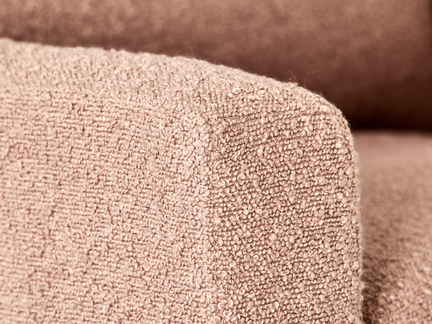 Pink boucle glider recliner chair with plush cushions and sleek design.