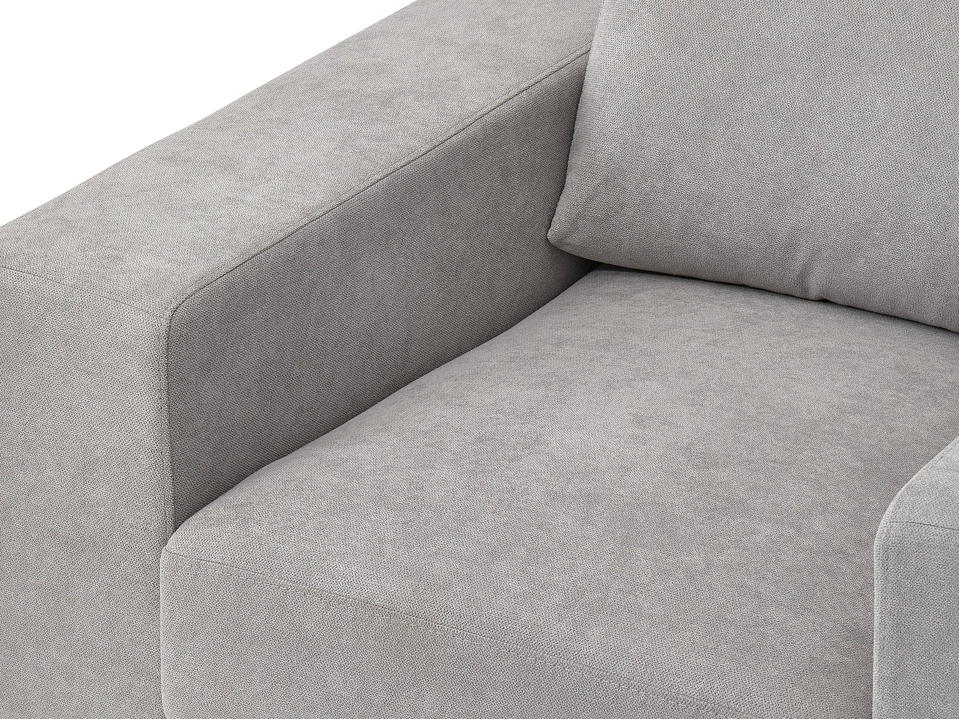 Light grey arm chair with wooden legs, tufted backrest, and contemporary design.