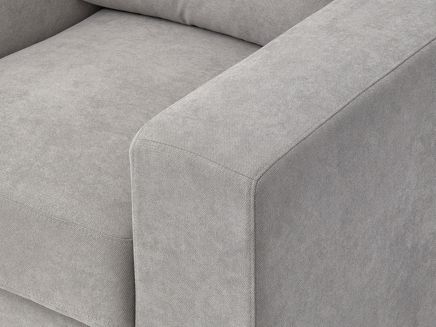 Light grey armchair with wooden legs, tufted backrest, and minimalist design for modern living rooms.