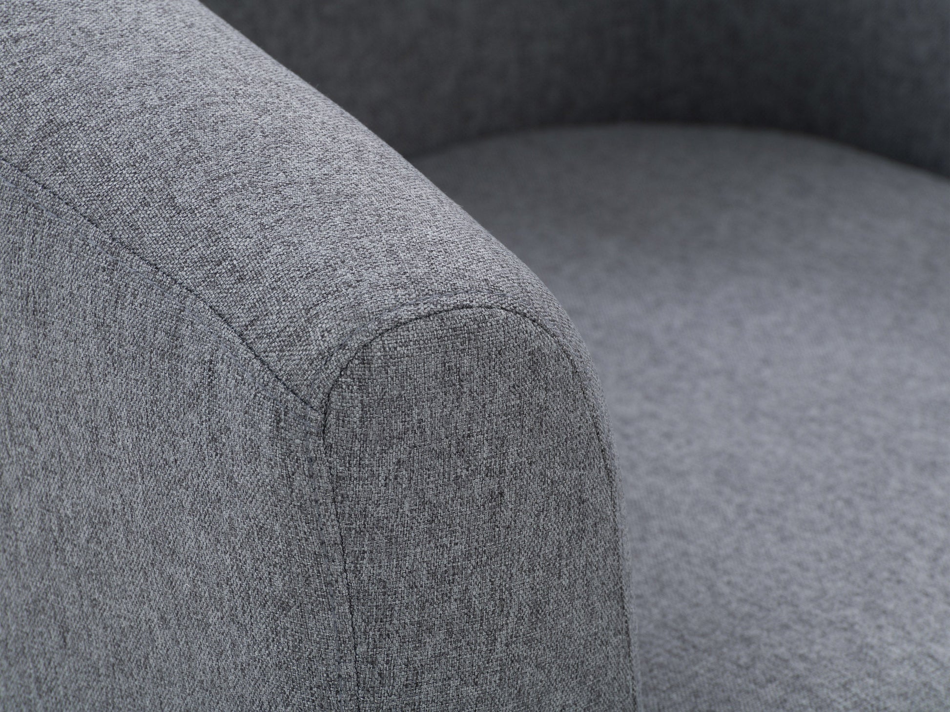 Grey tub accent chair with plush fabric upholstery, curved backrest, and wooden legs.