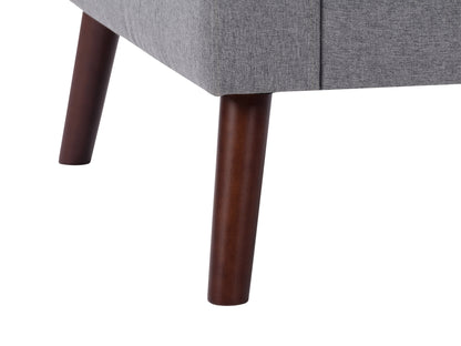 Tufted grey accent chair with wooden legs, soft fabric upholstery, and a modern minimalist design.