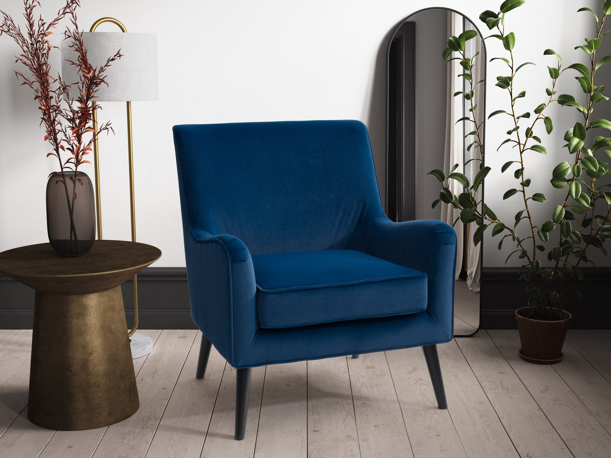 Blue velvet accent chair with curved back, gold metal legs, and plush cushioning for modern living rooms.