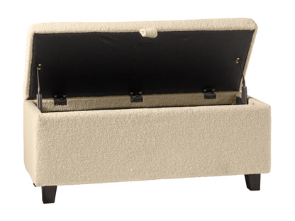 Cream boucle storage ottoman with hidden compartment, wooden legs, and tufted top for modern living spaces.