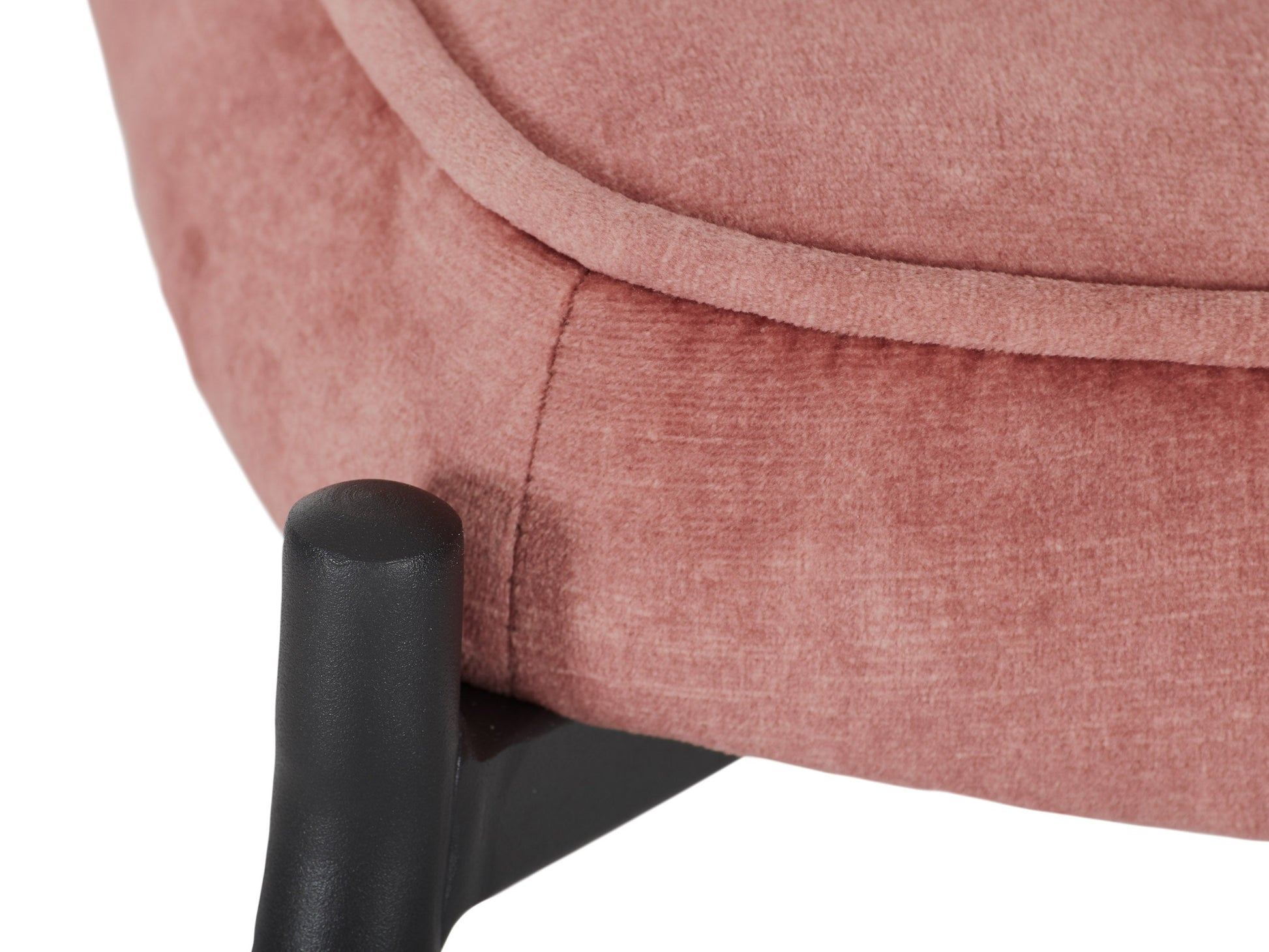 Salmon pink velvet accent chair with matching ottoman, featuring plush cushions and sleek wooden legs.