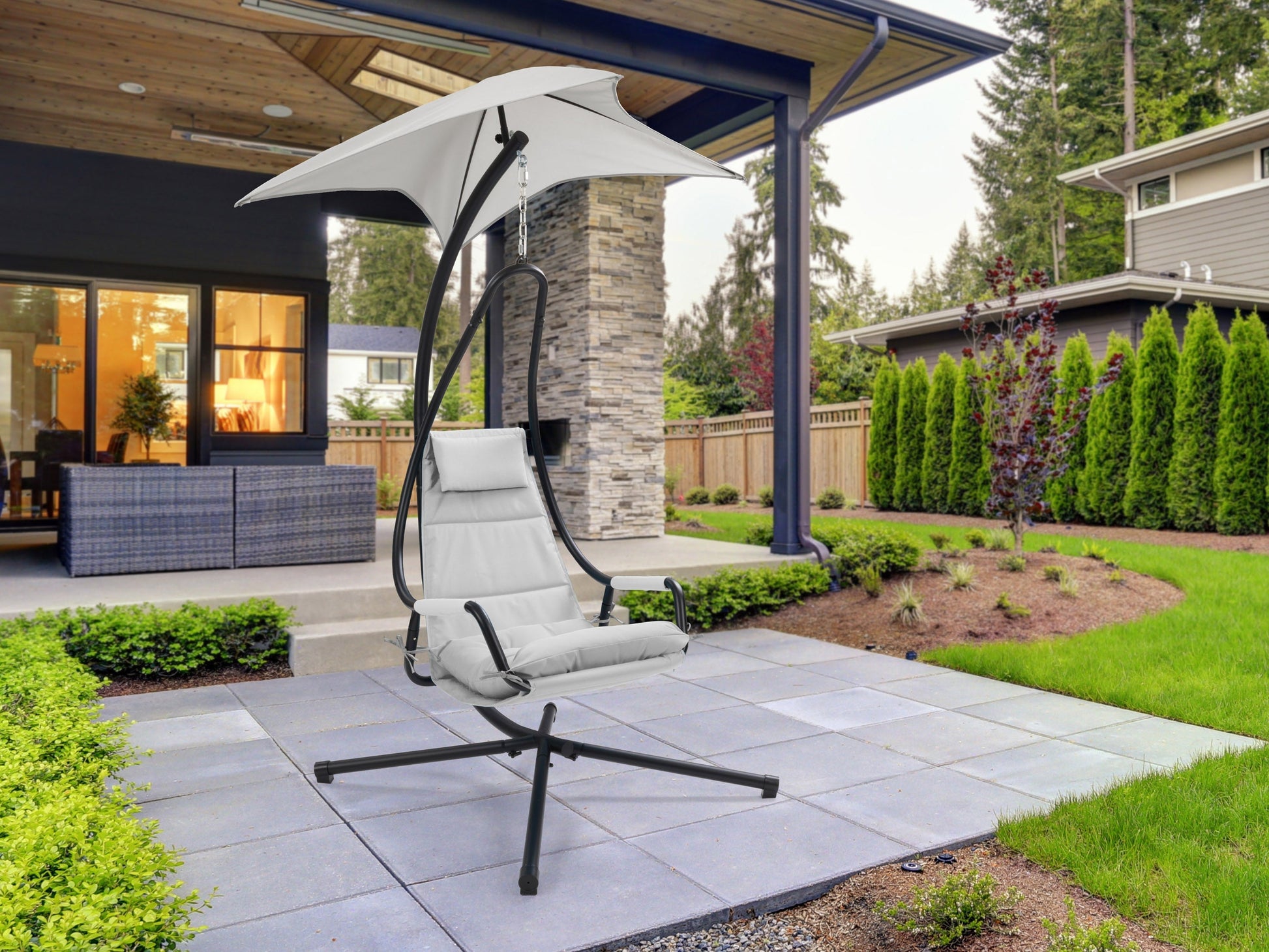 Light grey patio swing lounge chair with cushioned seat, sturdy frame, and weather-resistant fabric.