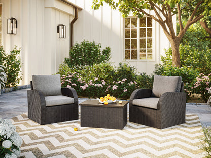 Grey outdoor wicker table and chairs set with cushions, perfect for patio conversations and garden lounging.