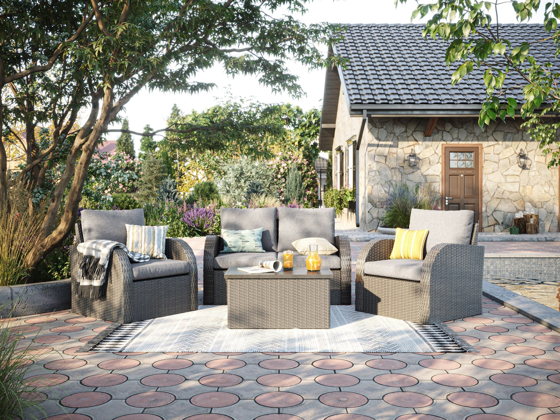 Grey outdoor loveseat set with cushions, including a coffee table, two chairs, and an ottoman, perfect for patio conversations.